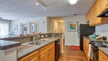 Fully equipped kitchens including refrigerator with ice maker, dishwasher & microwave